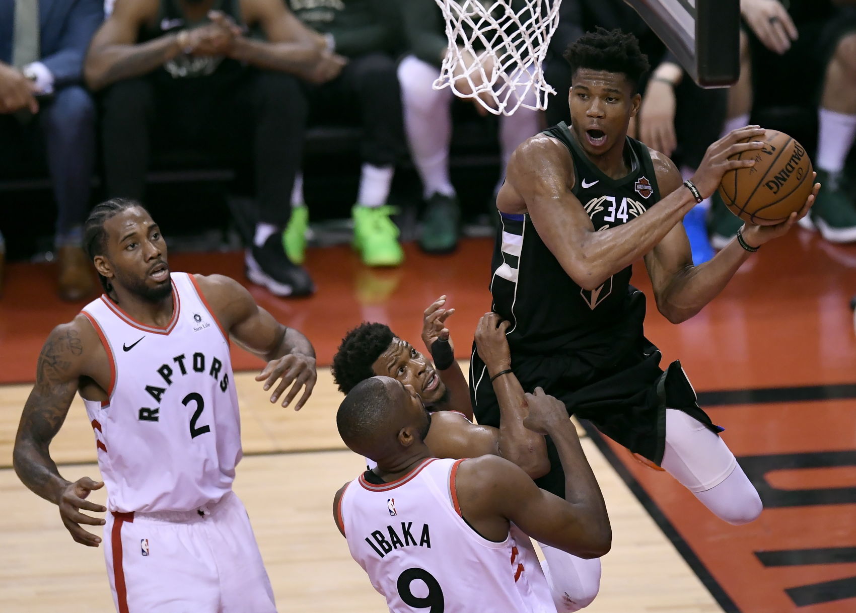 Giannis Antetokounmpo swarmed by Raptors, AP photo